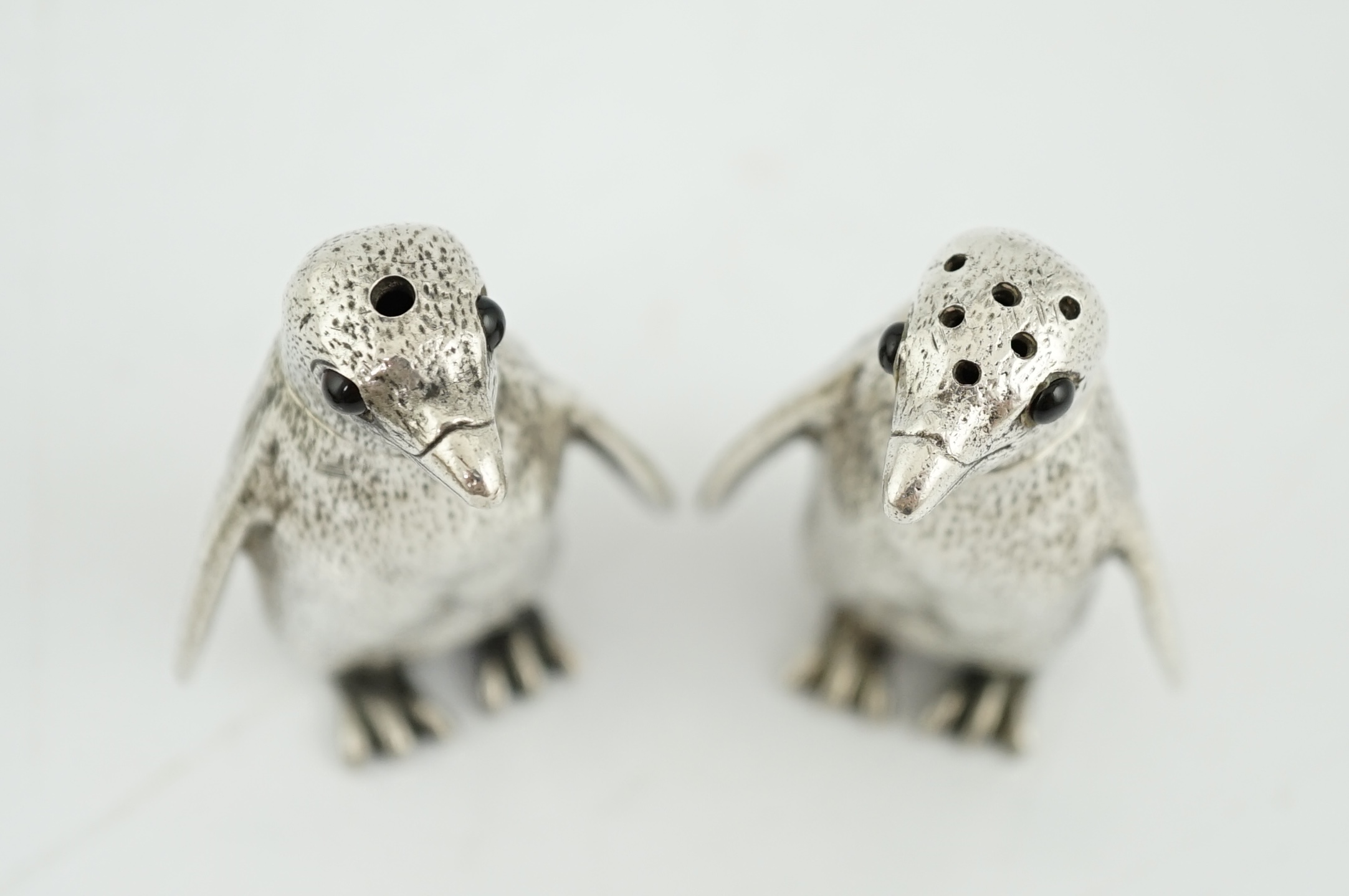 A pair of Elizabeth II silver novelty condiments, modelled as penguins, William Comyns & Sons Ltd
